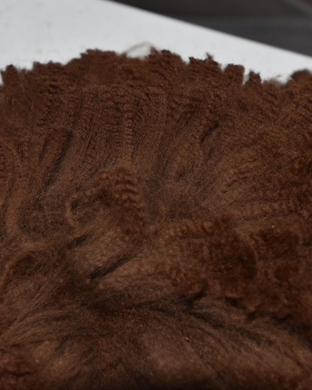 Raw brown alpaca staples showing the crimp along each lock. Grown on our own herd at Mulgoa and supplied unwashed.